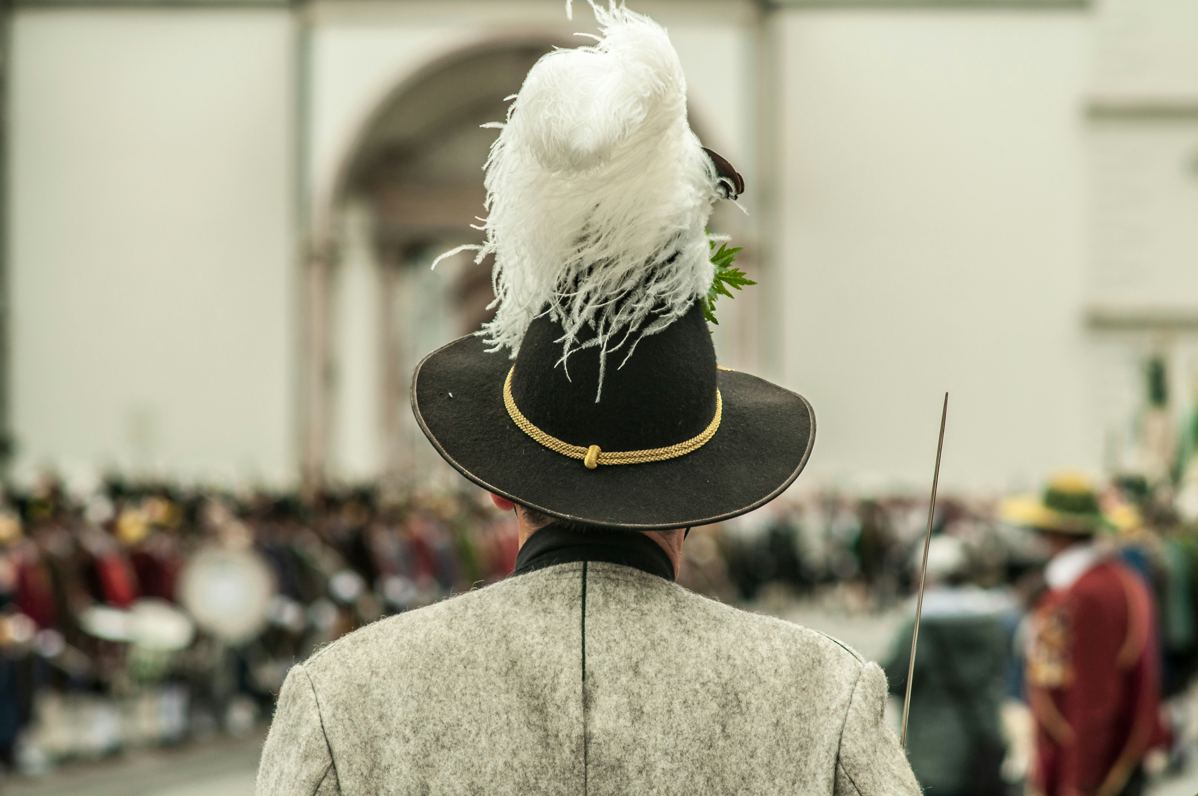 men wearing a feathered hat during daytime