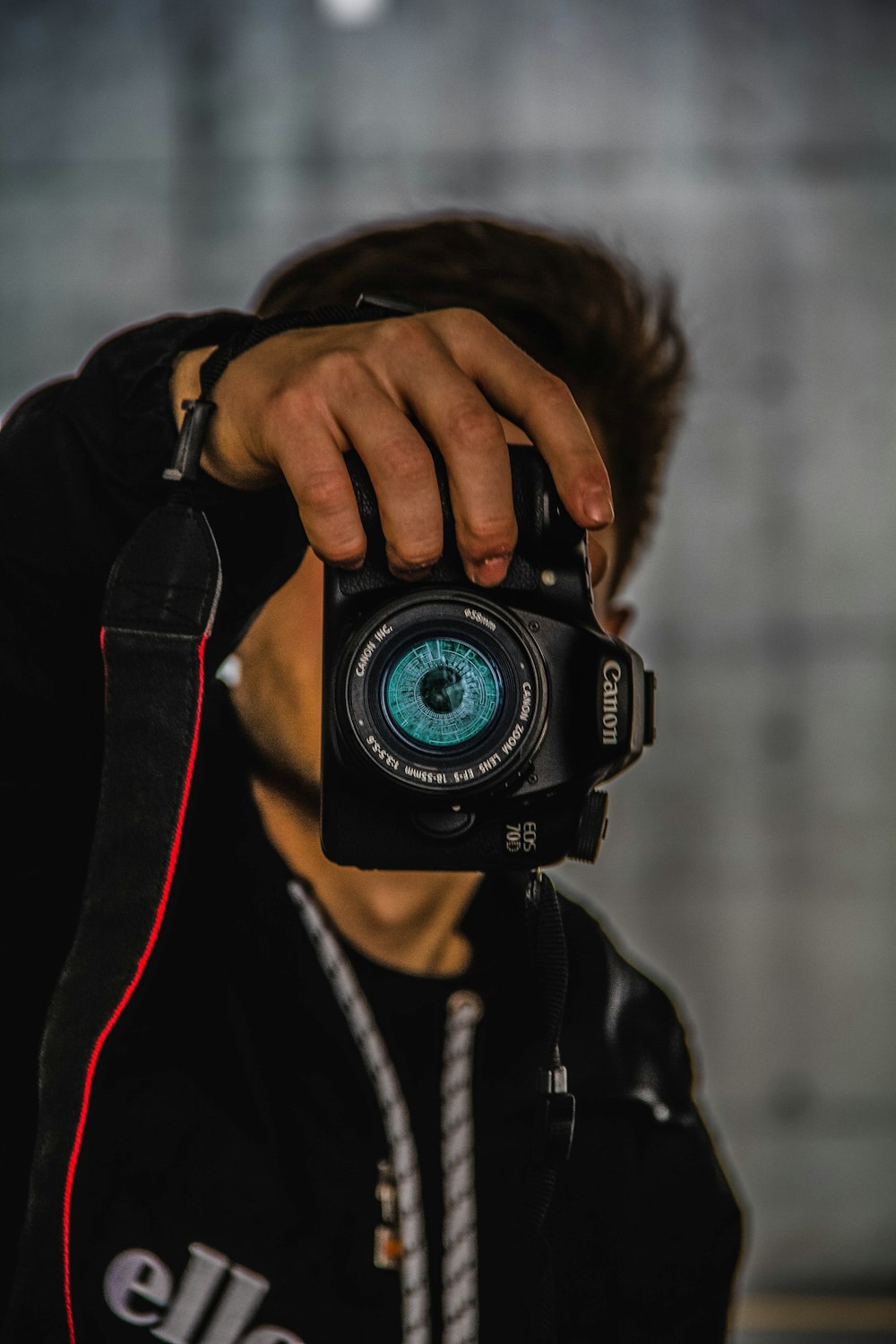 man holding Canon DSLR camera