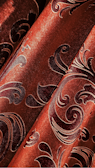 Seasonal collection fabrics with rich copper and burgundy highlights displayed.