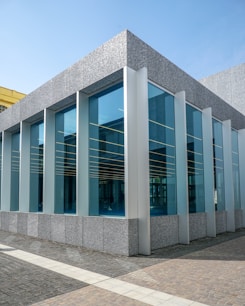 Wide shot of a building exterior covered in sleek black granite panels under natural sunlight.