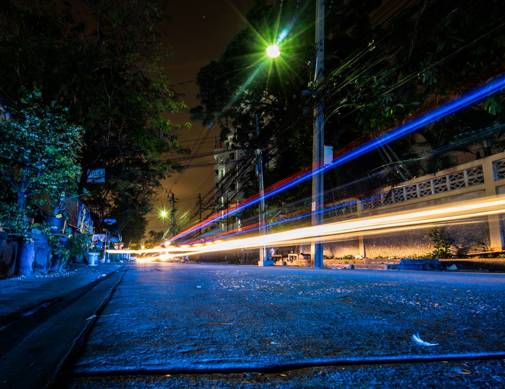 time lapse photography of vehicles passing by street during nighttime