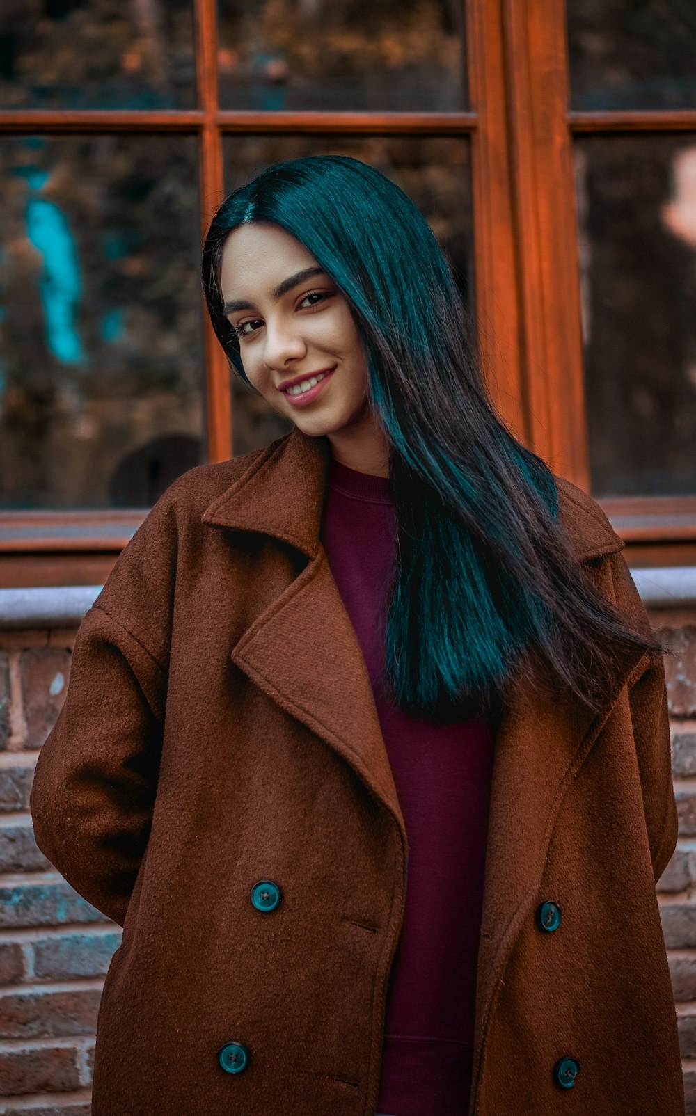 women's maroon crew-neck shirt and brown coat