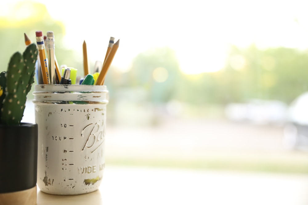 yellow pencil on white mason jar