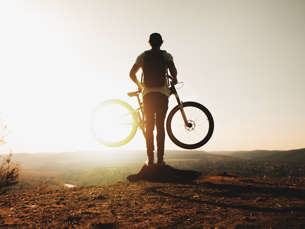 man carrying bike