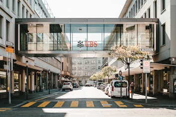 UBS logo on glass bridge wall during daytime