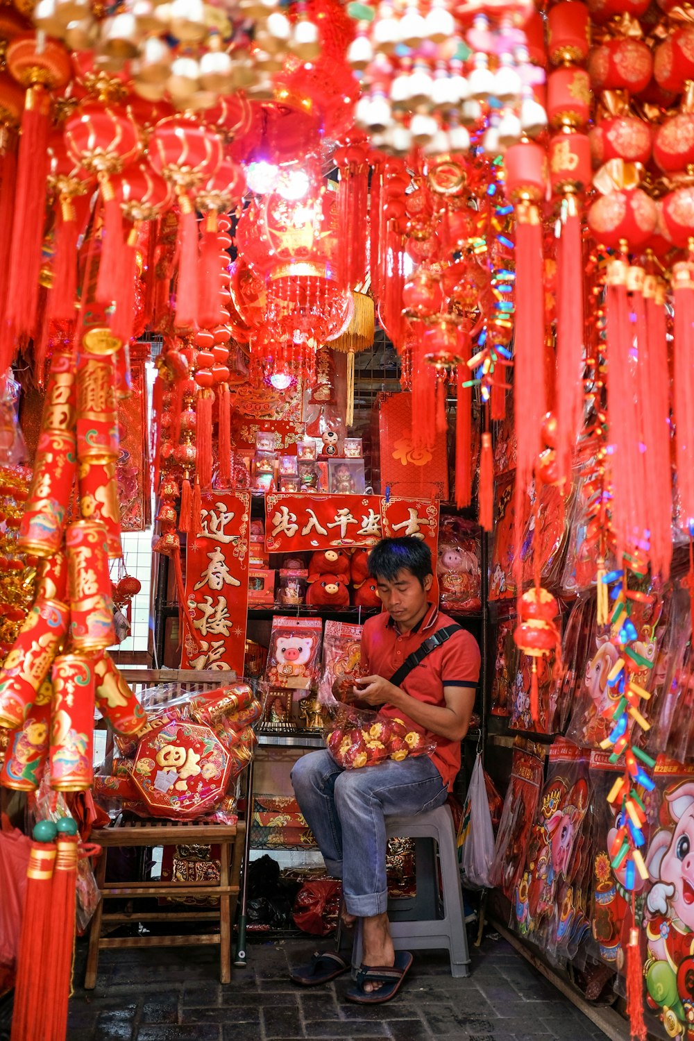 man wearing blue jeans sitting on lantern store