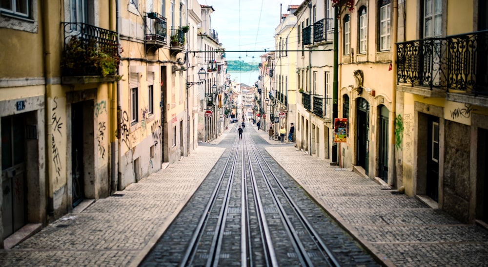 a train track running through a narrow city street