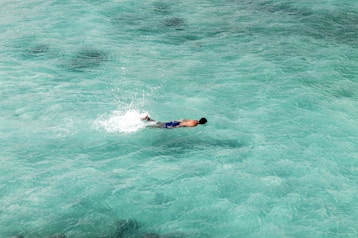 man swim on ocean
