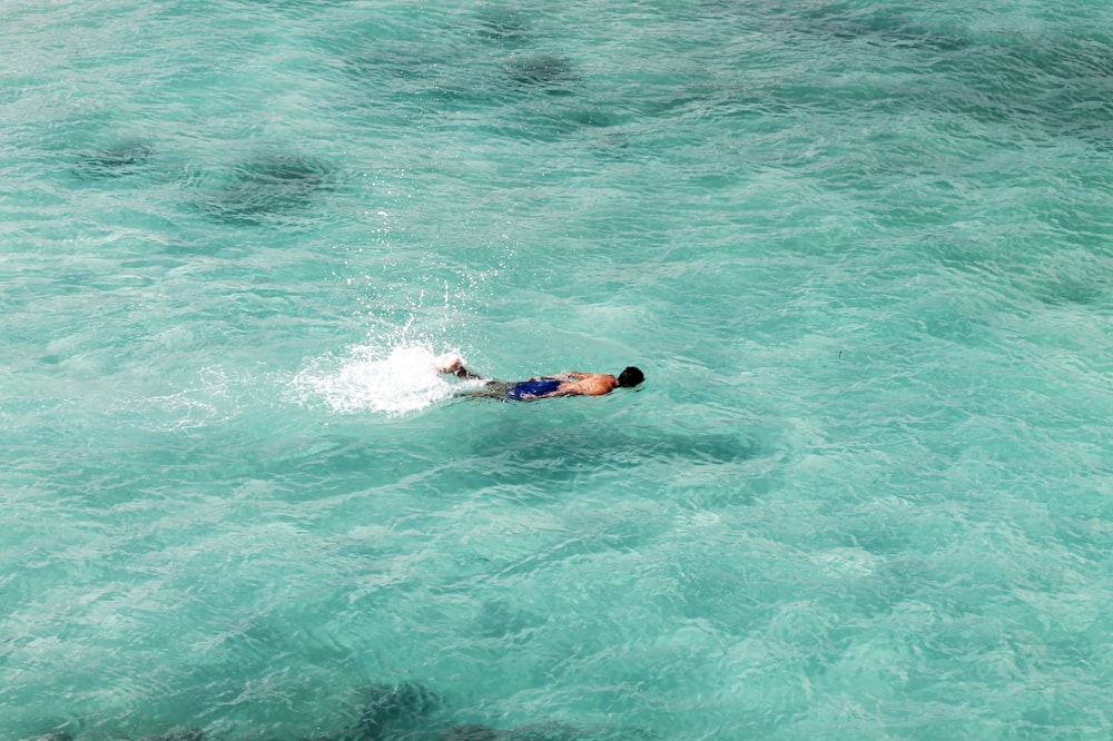 man swim on ocean