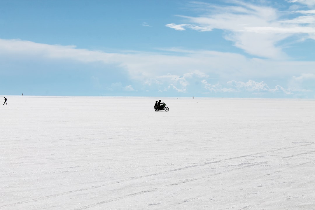 group of people standing on snow,