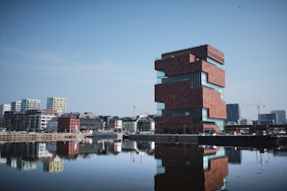 concrete buildings near body of water