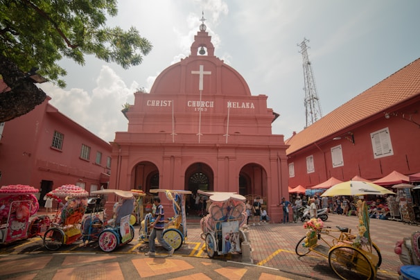Traditional trishaws lined up along the colorful streets of Melaka’s historic district.