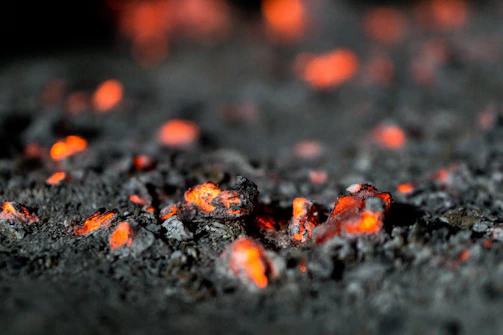 a close up of lava rocks with red lights