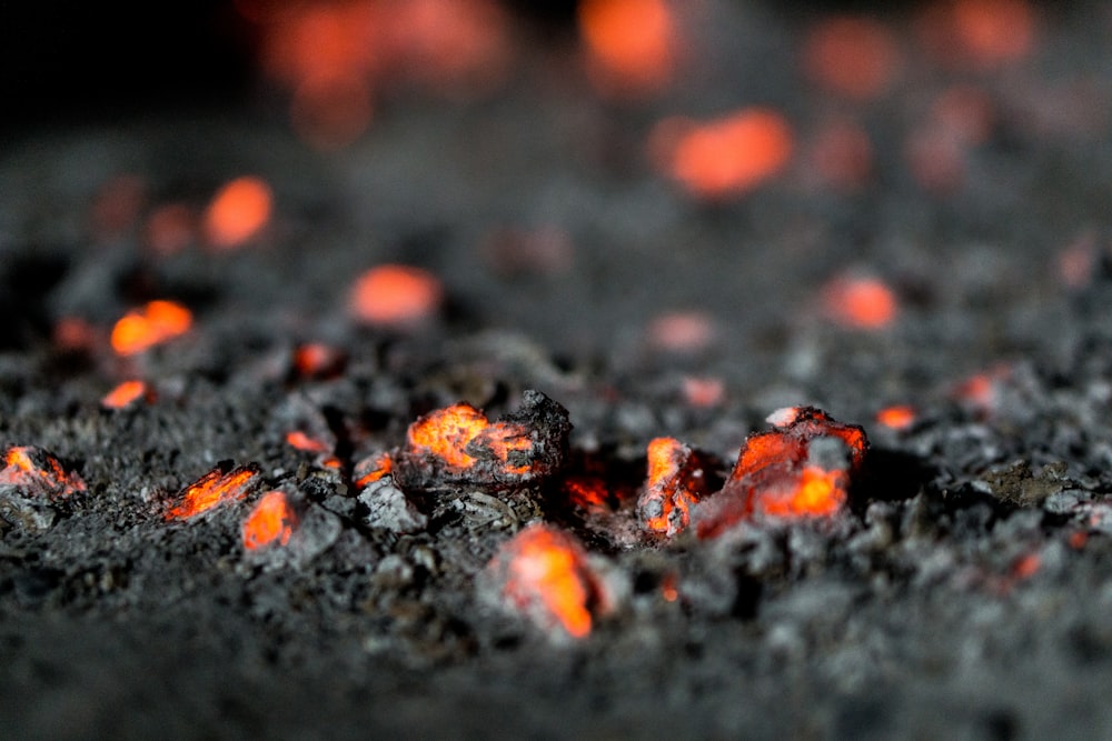 a close up of lava rocks with red lights