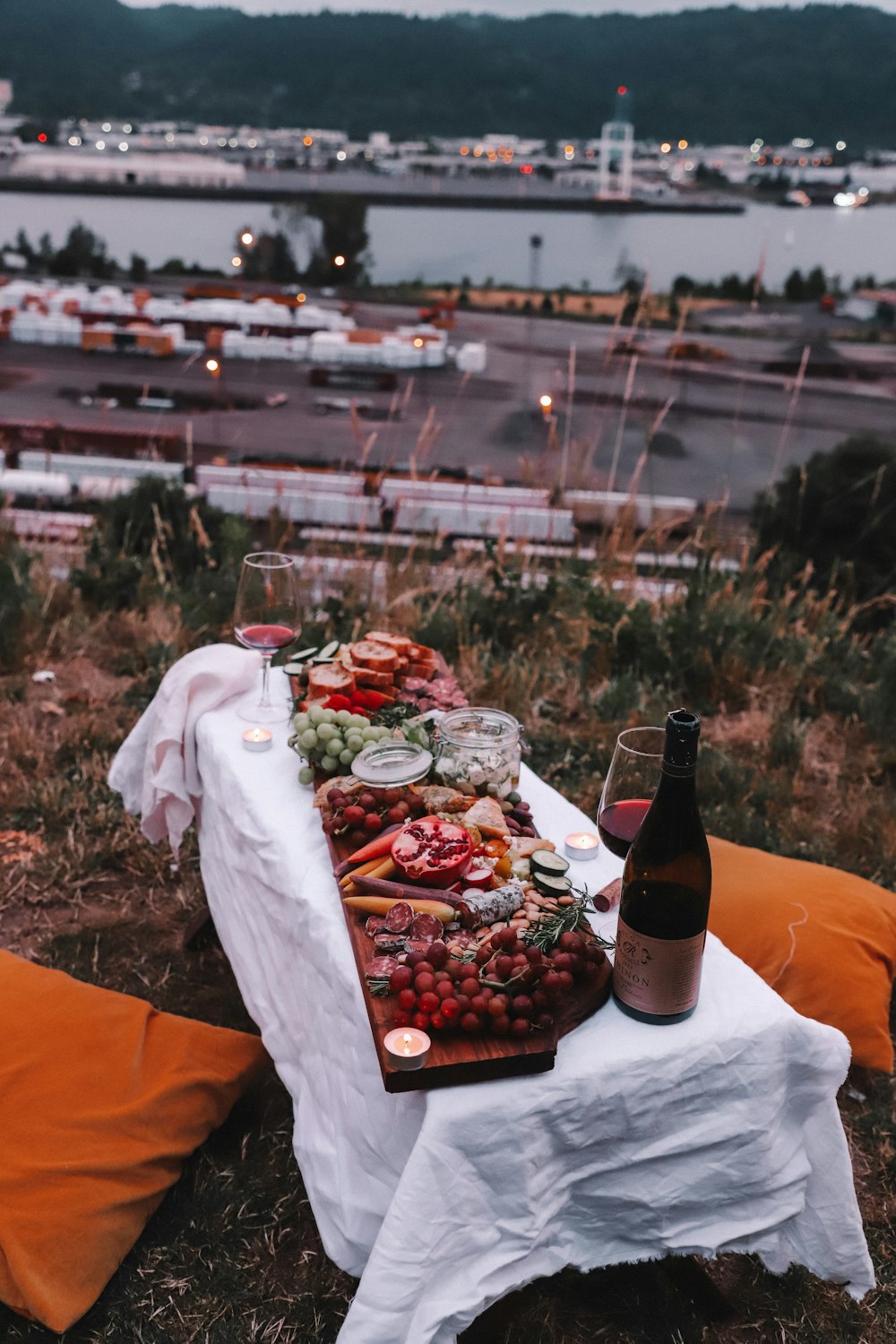 assorted grapes and wine bottle on table