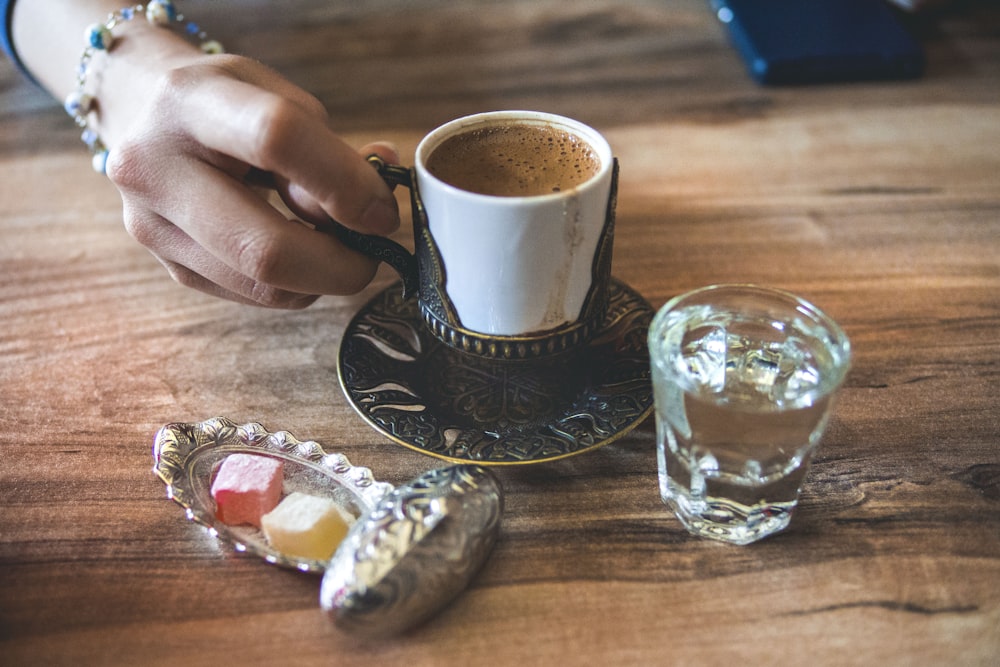 white ceramic cup near mug