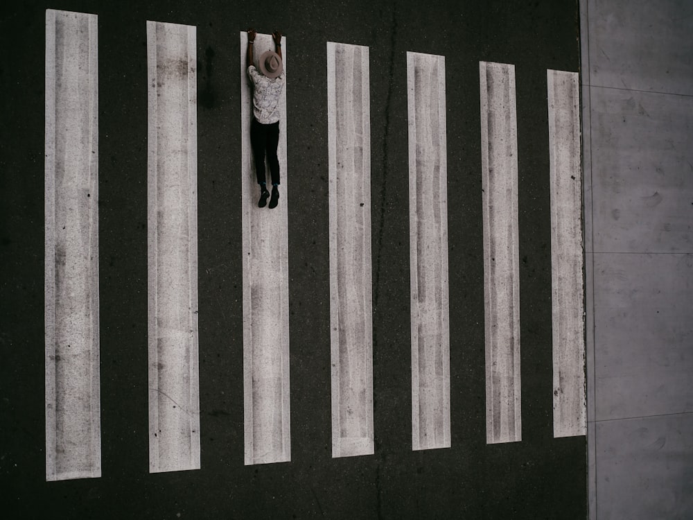 person lying on pedestrian lane