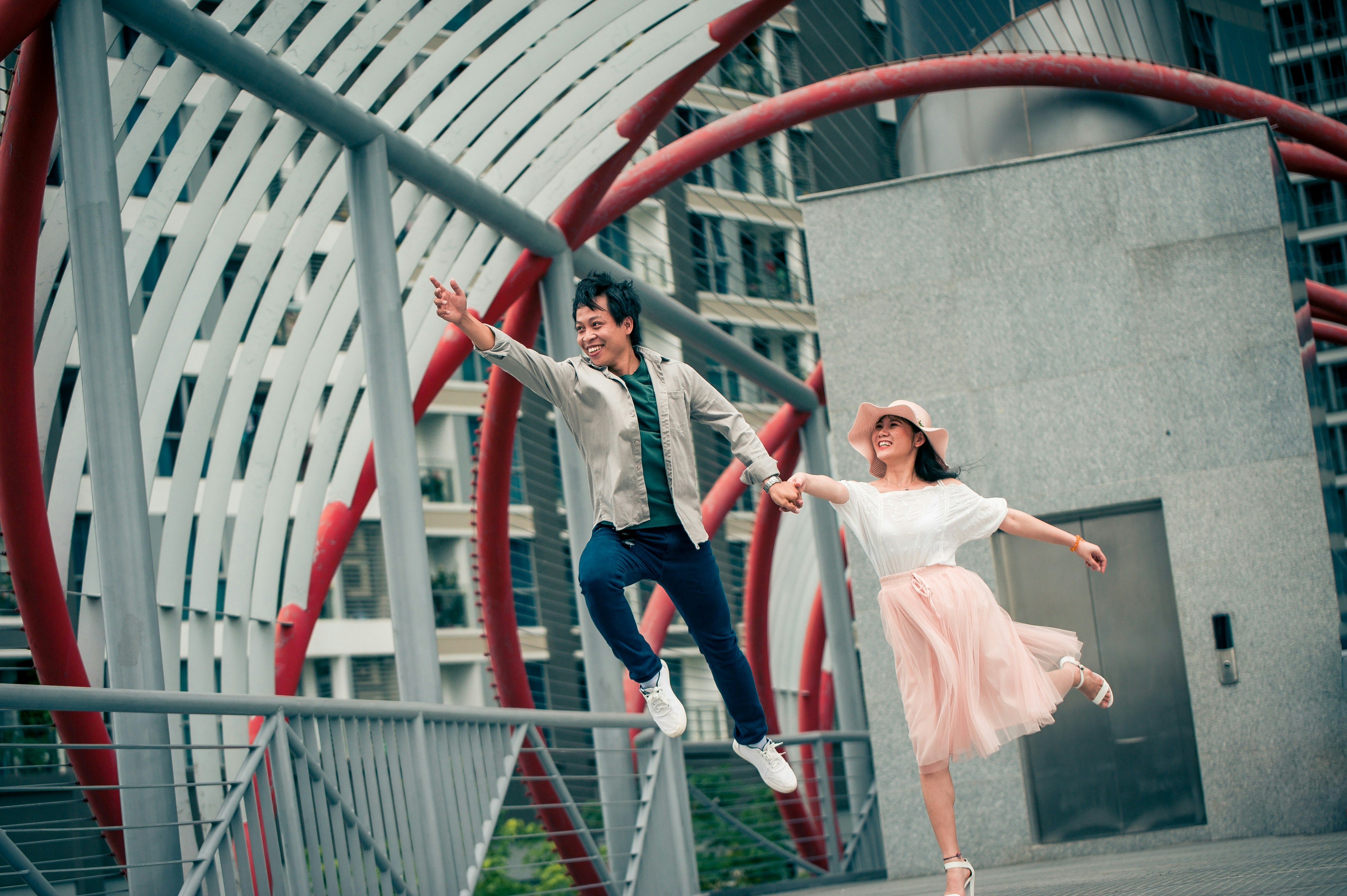 shallow focus photo of man and woman jumping