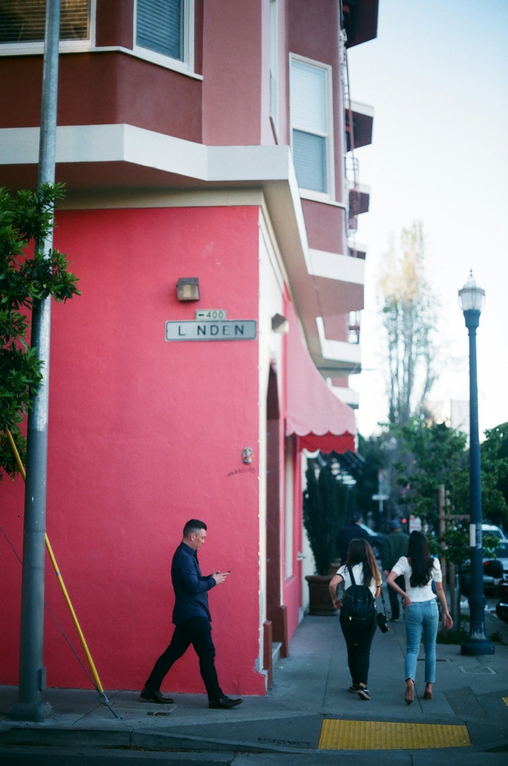 people walking near red building