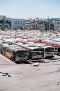 Engineers installing mobility service hardware on a city street with electric buses.