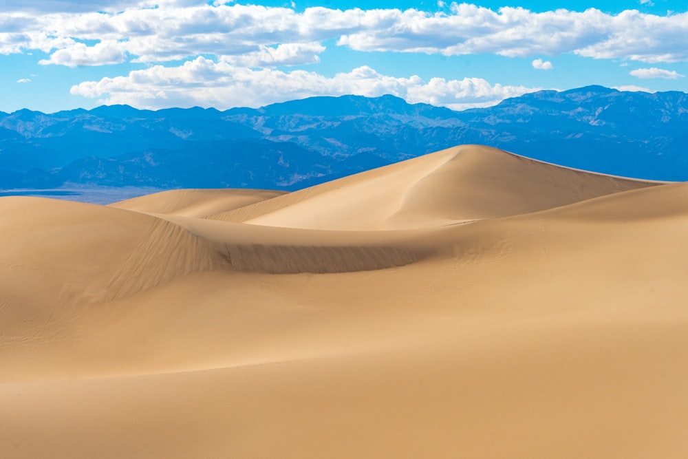 landscape photo of mountains under cloudy sky