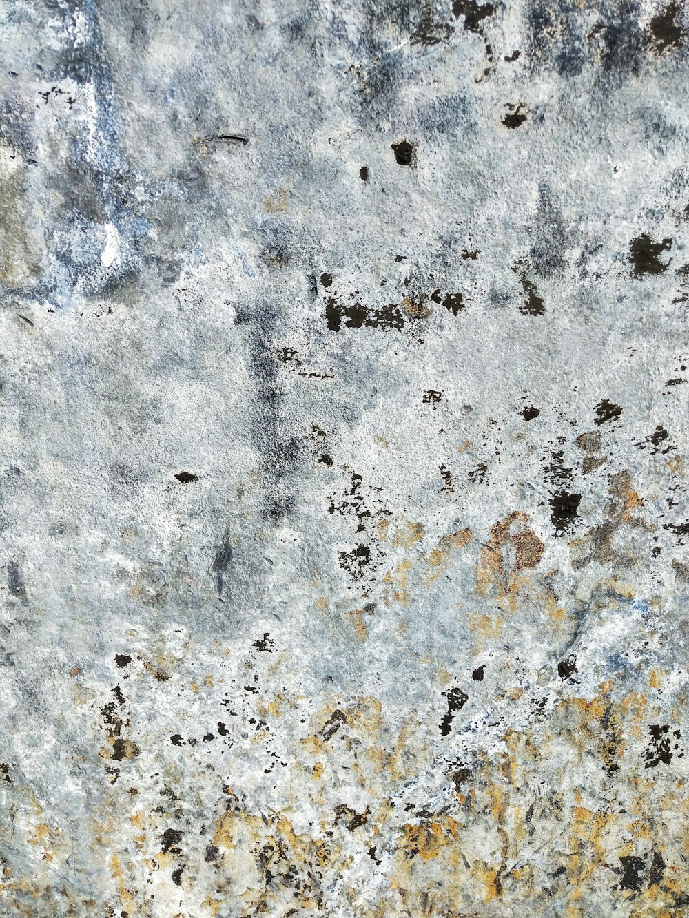 a close up of a concrete wall with a rusted surface
