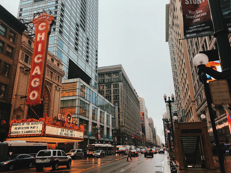 Traffic on a rain-slicked downtown Chicago street near the Chicago Theatre marquee