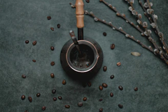 black teapot with coffee beans