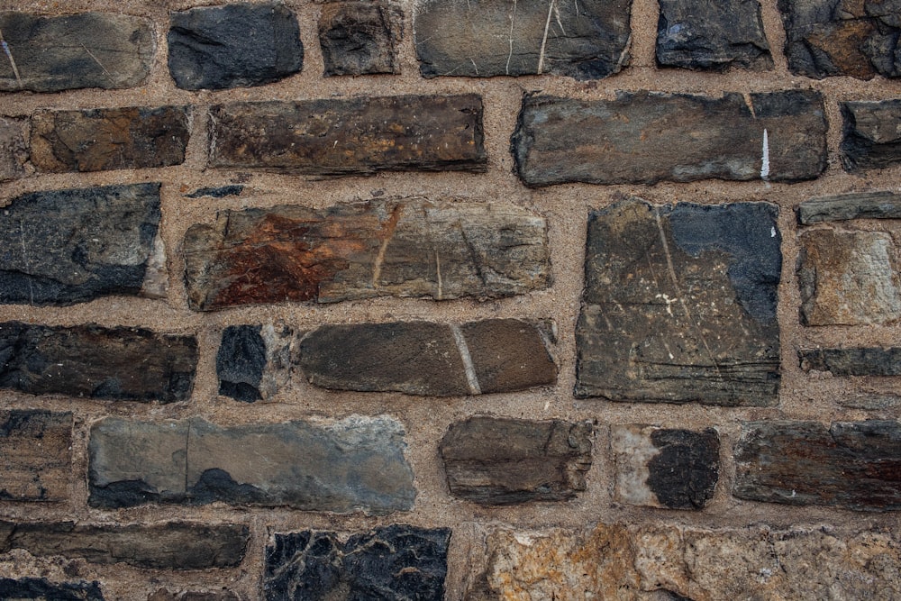 a close up of a brick wall made of stones