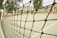 A close-up of a sturdy sports net stretched tightly over a cricket practice area in Chennai.