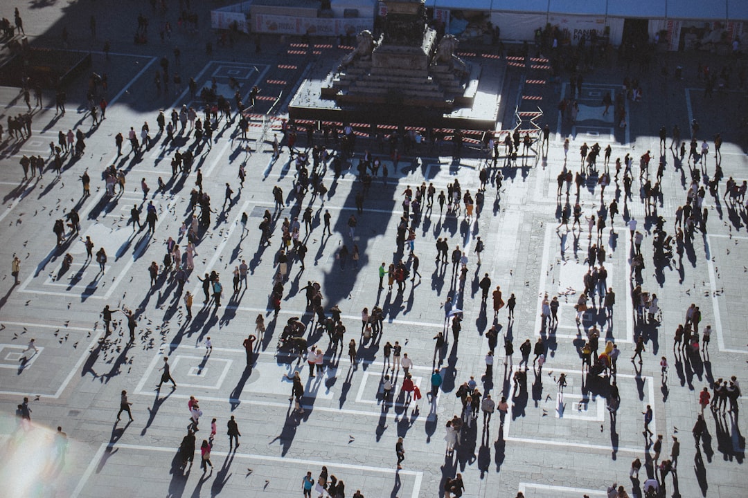 people near statue,