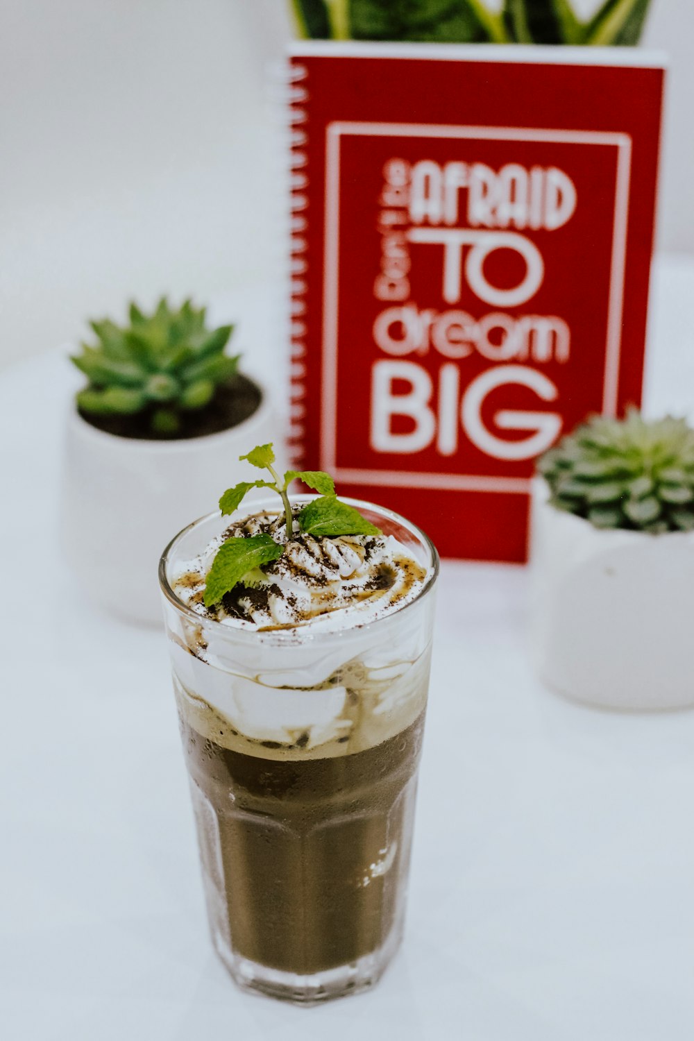 coffee on pint glass near plants