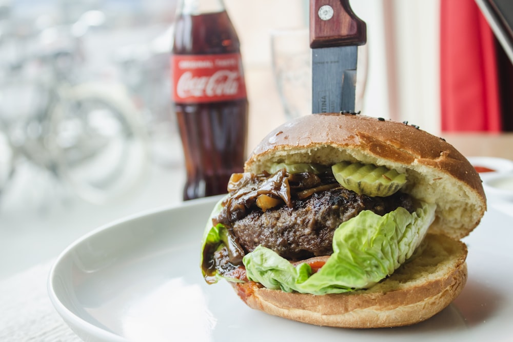 burger near Coca-Cola bottle