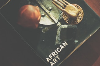 Image showing a traditional African book and pen on a wooden desk symbolizing literary heritage.