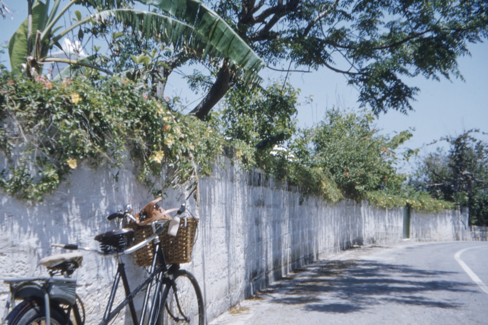 black bicycle parked beside wall