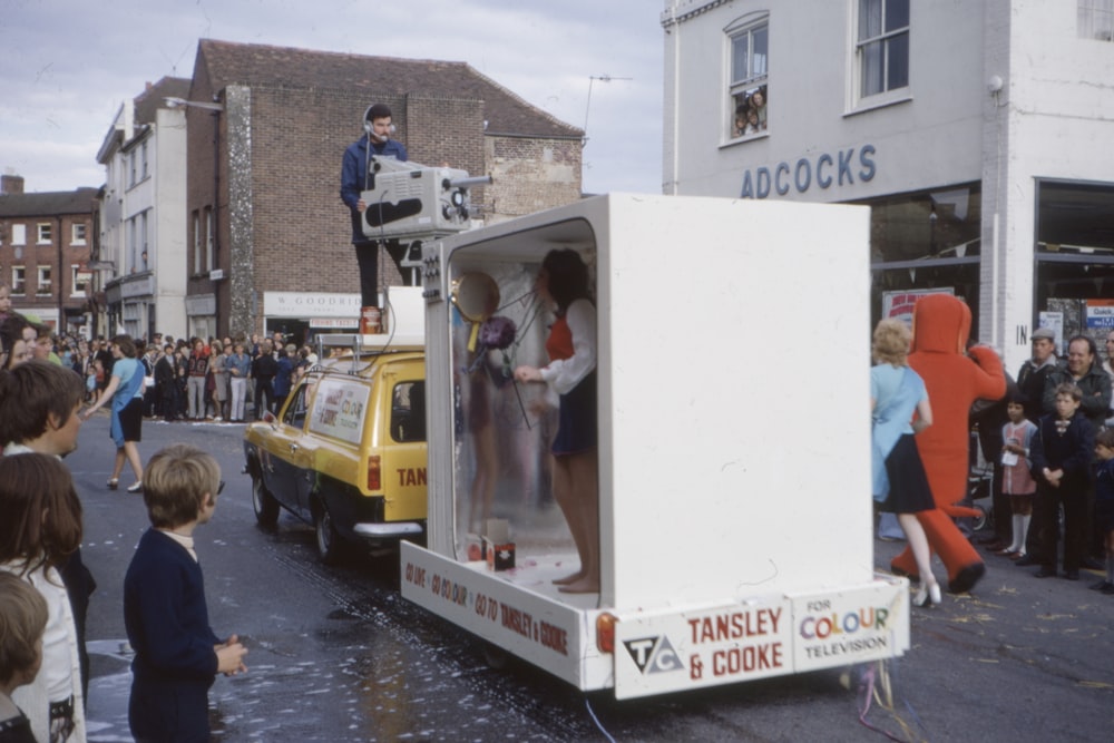 man standing on top of yellow vehicle