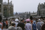 A solemn gathering of knights and ladies in traditional Manueline attire during a ceremonial event.