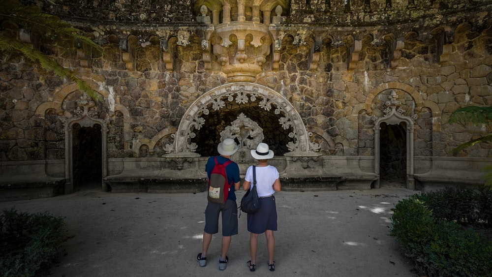 two person standing near building