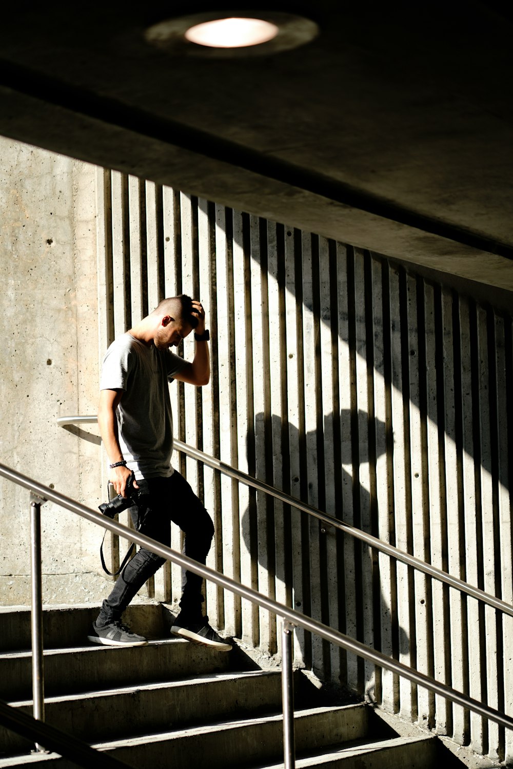 man in stair holding camera