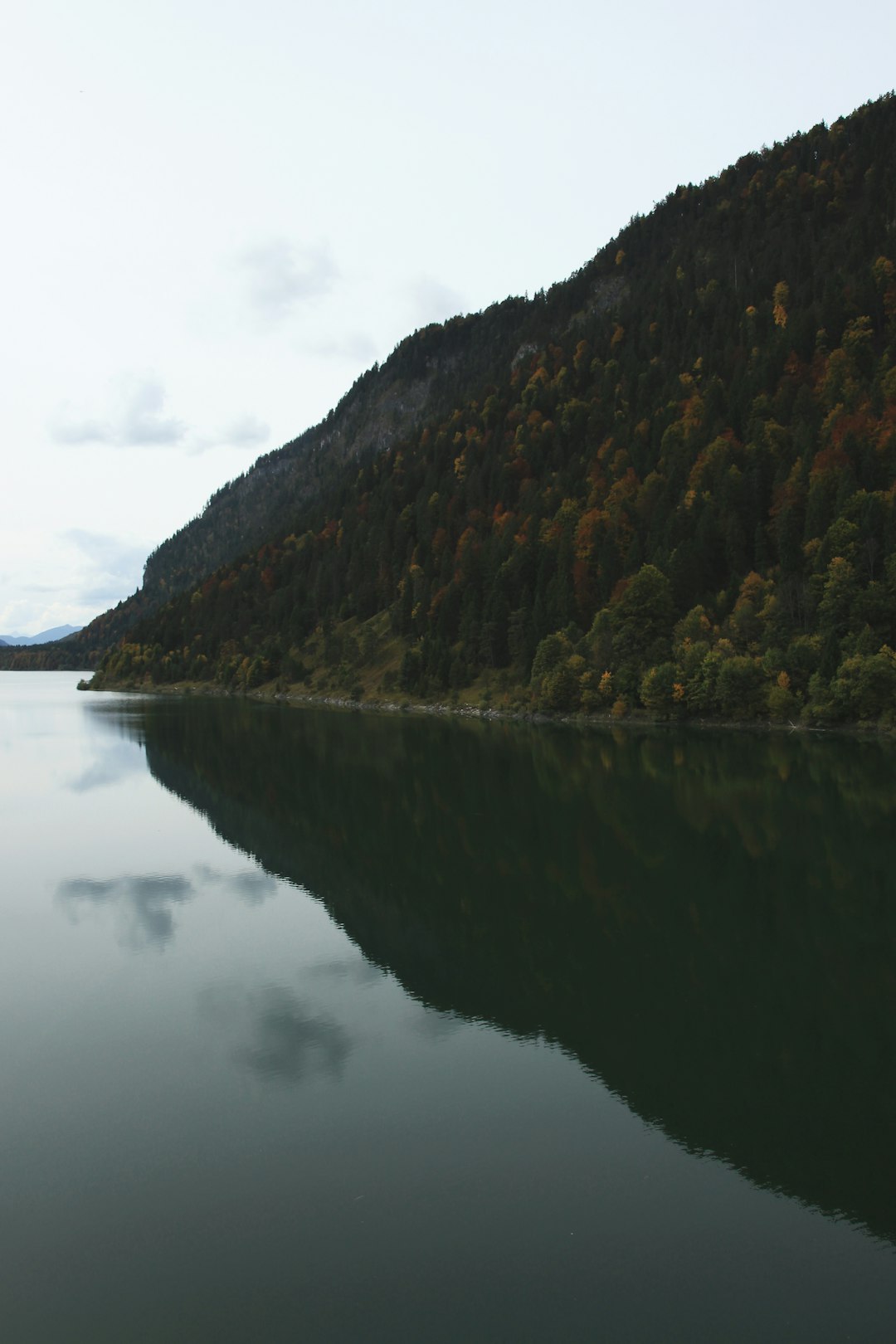 reflection of mountain on body of water