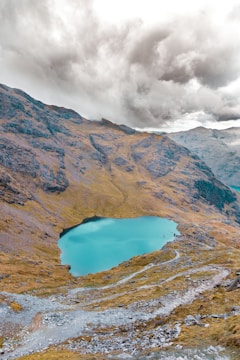 body of water near mountaini