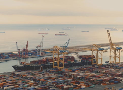 A busy port with containers and cargo ships symbolizing global trade activities.