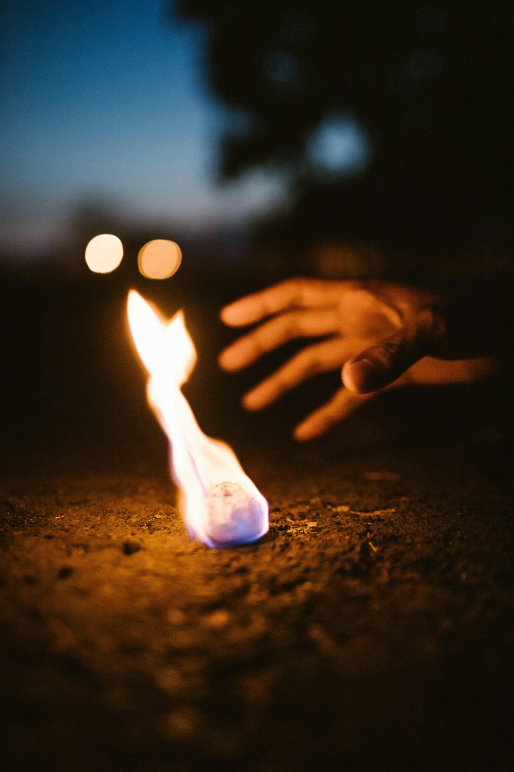 person's hand near fire
