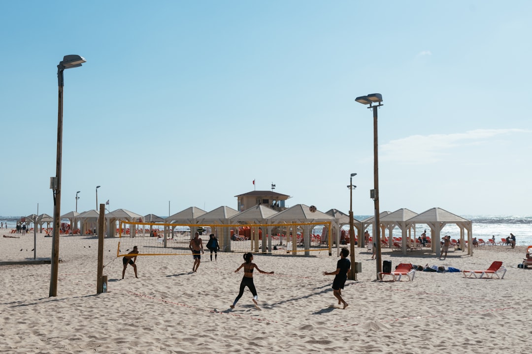 three person playing volleyball,