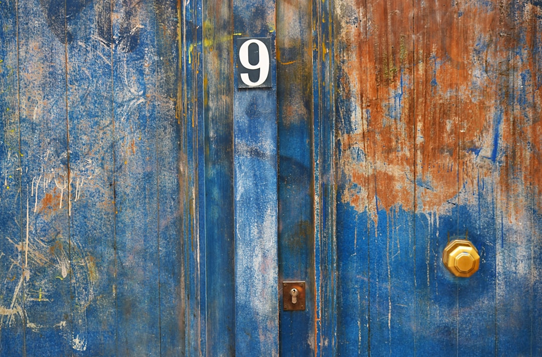 blue-painted metal door with number 9