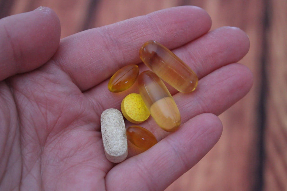 person holding medication pills