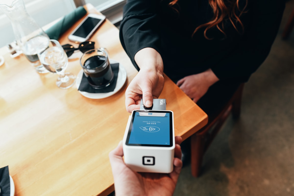 Person Holding Credit Card Swipe Machine
