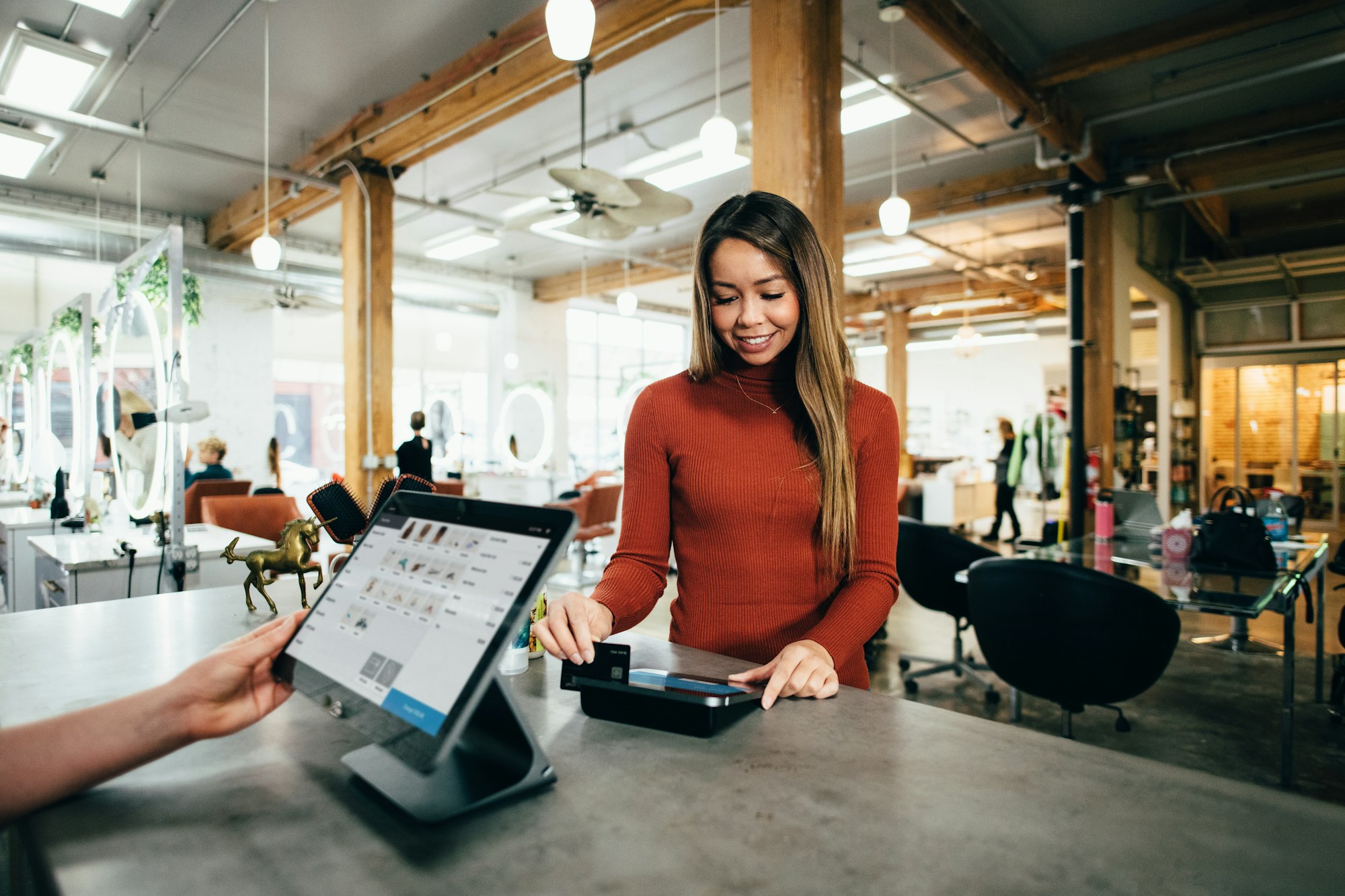 Image of woman paying for something with a debit card
