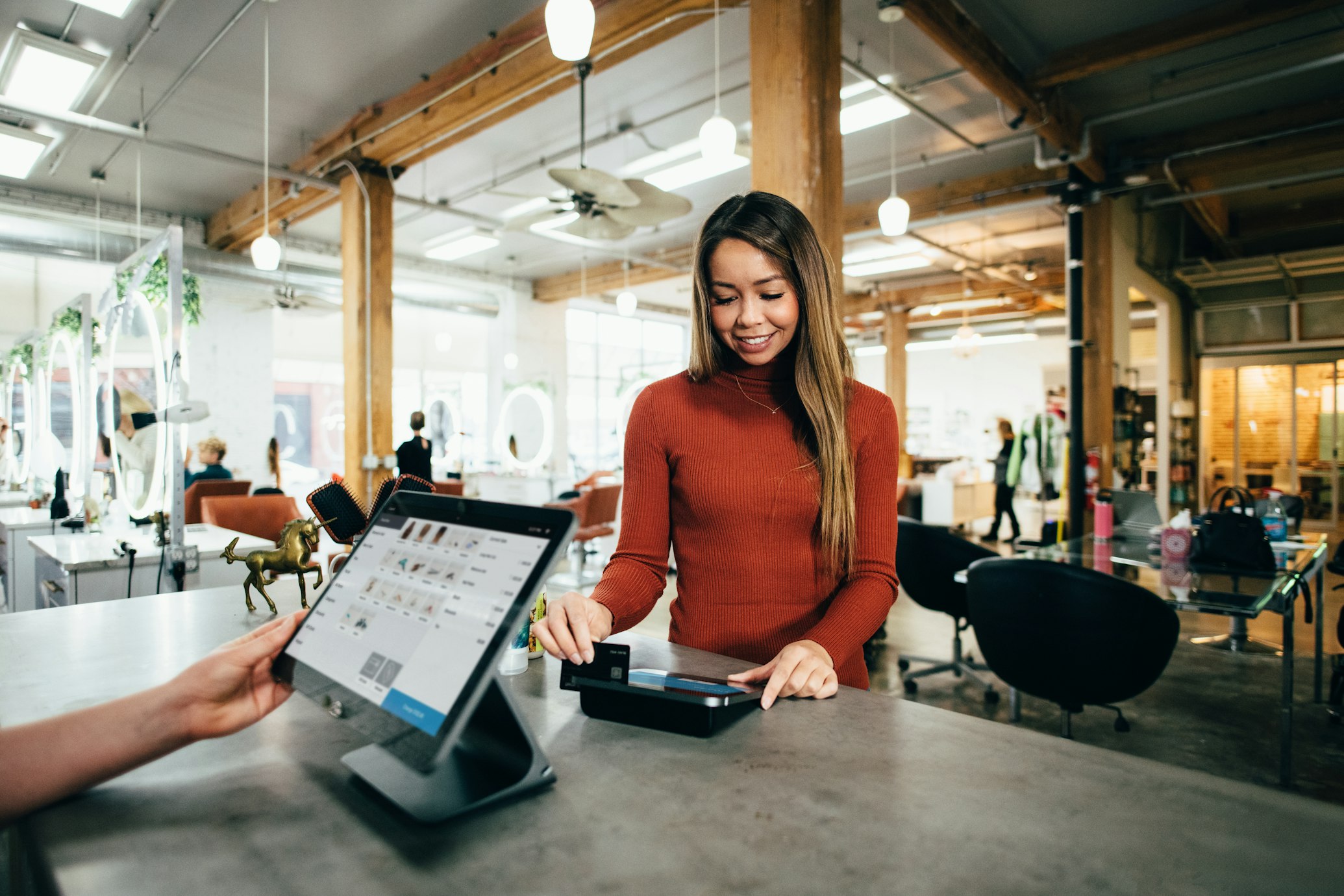 A person completing a purchase on a tablet, symbolizing high conversion rates