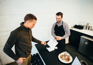 man looking at white digital device